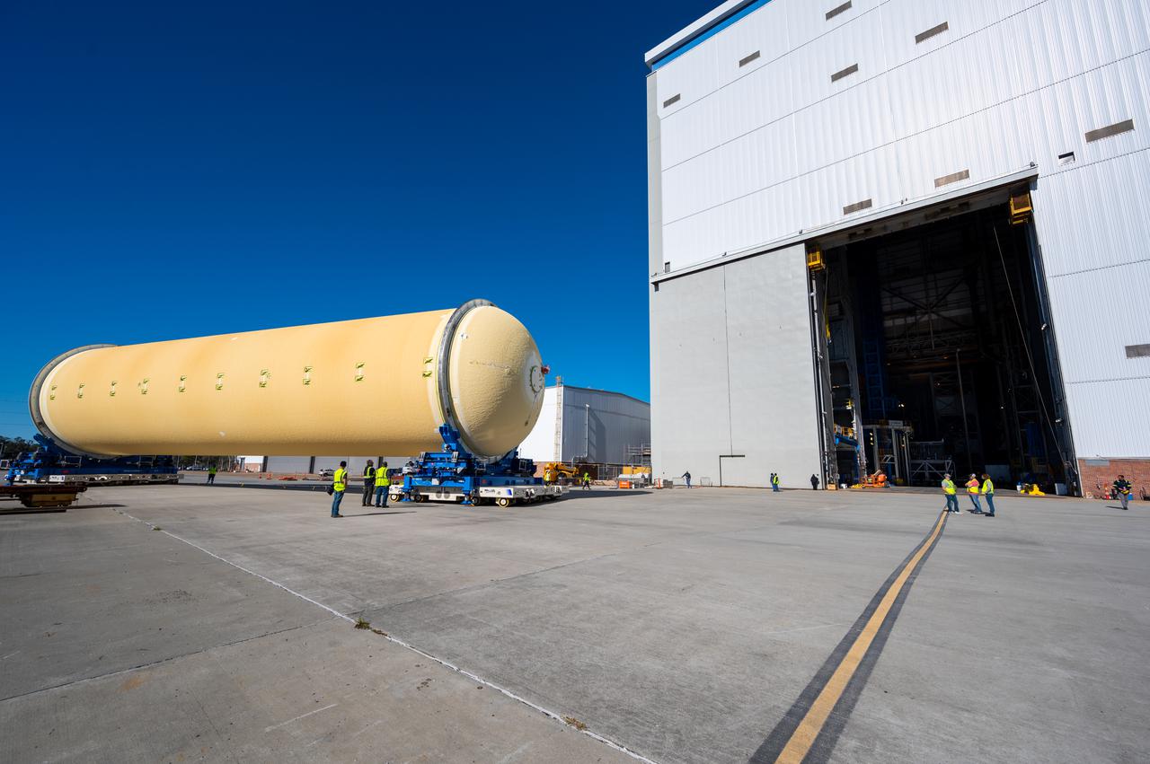Technicians transported the assembled upper part of the Artemis II core stage to the final assembly area inside the factory at NASA’s Michoud Assembly Facility in New Orleans. On Jan 10, the forward assembly, left was moved next to the Artemis II liquid hydrogen tank, which has been undergoing assembly. Next, Boeing, the lead core stage contractor, will join the forward assembly and the liquid hydrogen tank to complete most of the core stage for the Space Launch System (SLS) rocket that will send the first crew on an Artemis mission. The core stage consists of five major structures that are built, outfitted, and then connected to form the final stage. The forward skirt, liquid oxygen and intertank were connected and tested to form the 66-foot forward assembly. After the forward assembly is joined with the 130-foot liquid hydrogen tank, only the engine section, the fifth piece of the stage, will need to be added to complete the Artemis II core stage. The core stage serves as the backbone of the rocket, supporting the weight of the payload, upper stage, and crew vehicle, as well as the thrust of its four RS-25 engines and two five-segment solid rocket boosters attached to the engine and intertank sections. On Artemis II, the SLS rocket will launch the Orion spacecraft and a crew, sending them into lunar orbit, in preparation for later Artemis missions that will enable the first woman and first person of color to land on the Moon.